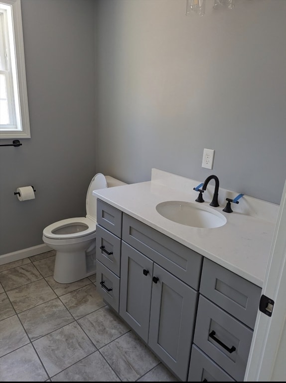 bathroom with vanity, toilet, and tile patterned flooring