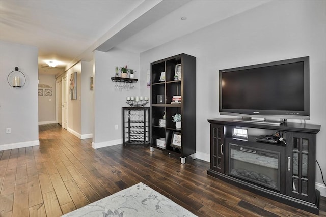 living area with wood finished floors and baseboards