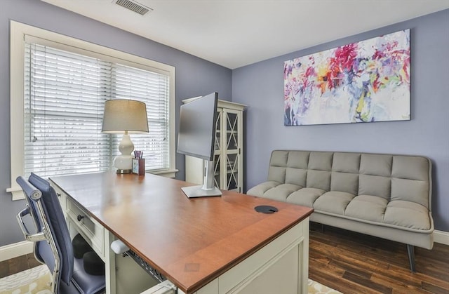 office area featuring visible vents, baseboards, and wood finished floors