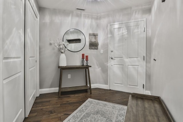 foyer featuring baseboards, visible vents, and hardwood / wood-style floors