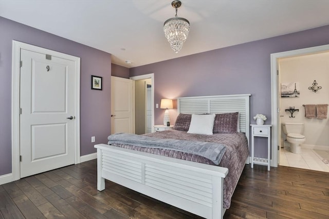 bedroom with wood-type flooring, baseboards, and an inviting chandelier