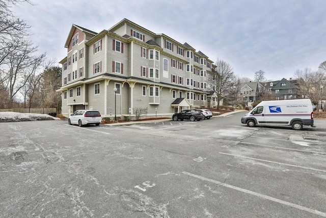 view of property featuring uncovered parking and a residential view