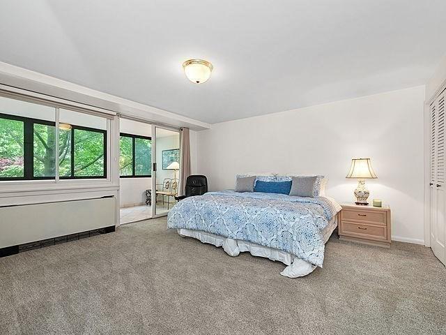 2 Hawthorne Pl Unit 2E & 2F, Boston, MA 02114 - carpeted bedroom featuring radiator heating unit and baseboards