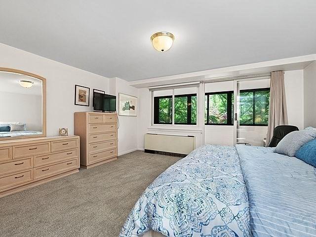2 Hawthorne Pl Unit 2E & 2F, Boston, MA 02114 - carpeted bedroom featuring arched walkways