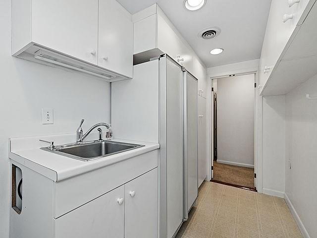 2 Hawthorne Pl Unit 2E & 2F, Boston, MA 02114 - laundry room featuring a sink, light flooring, recessed lighting, and baseboards