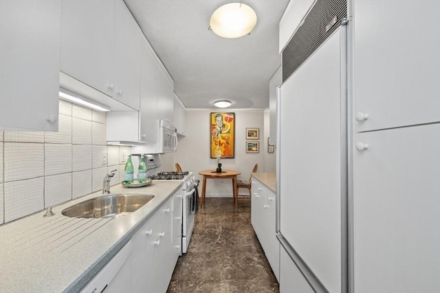 2 Hawthorne Pl Unit 2E & 2F, Boston, MA 02114 - kitchen featuring a sink, white appliances, white cabinetry, light countertops, and backsplash