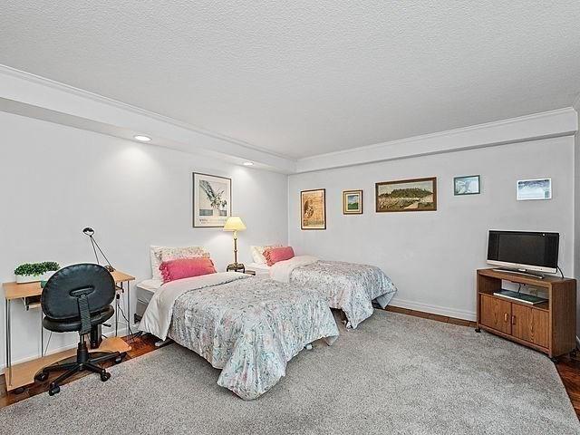 2 Hawthorne Pl Unit 2E & 2F, Boston, MA 02114 - bedroom featuring wood finished floors, ornamental molding, baseboards, recessed lighting, and a textured ceiling
