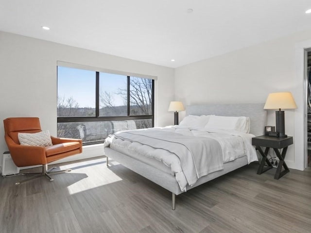 bedroom featuring recessed lighting and wood finished floors
