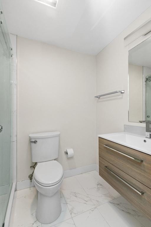 full bath with a shower stall, marble finish floor, baseboards, and vanity