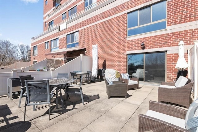 view of patio featuring fence and outdoor dining area