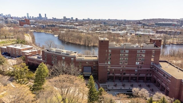 birds eye view of property with a water view and a view of city