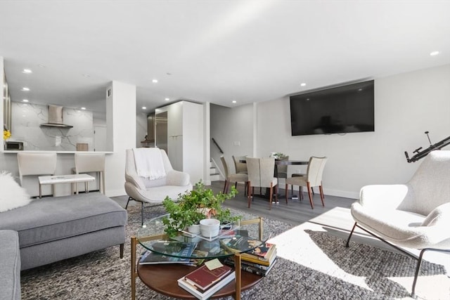 living area featuring wood finished floors, recessed lighting, and stairs