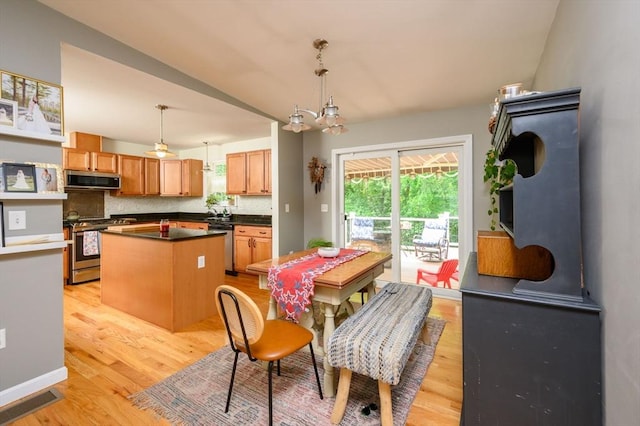 89 Block St, Abington, MA 02351 - dining room with light wood-type flooring and a chandelier