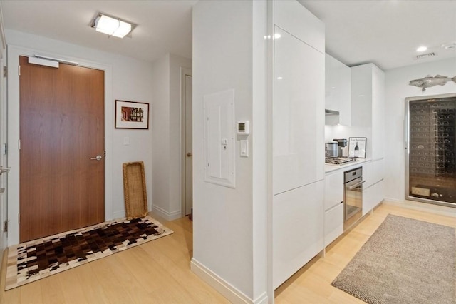 interior space featuring baseboards and light wood-style floors