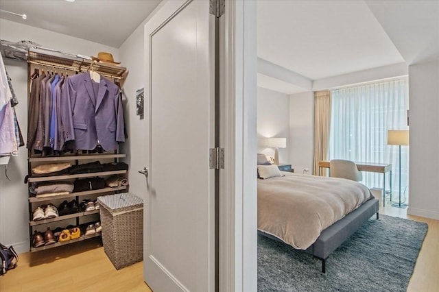 bedroom with wood finished floors and baseboards