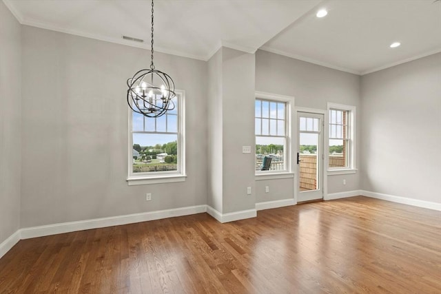 interior space featuring wood-type flooring, crown molding, and a chandelier