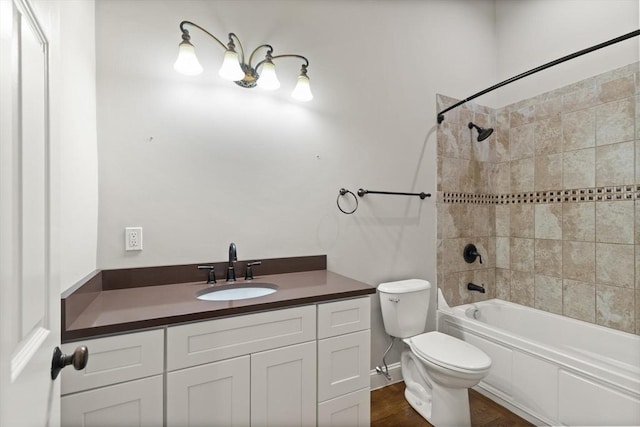 full bathroom featuring toilet, tiled shower / bath combo, and vanity