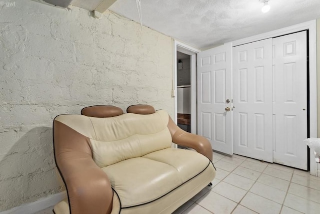sitting room with light tile patterned floors and a textured ceiling