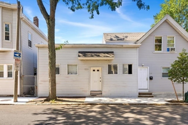 view of property featuring entry steps and a gate