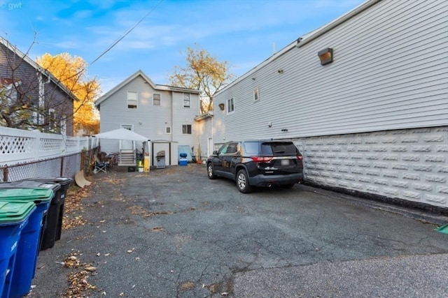 view of side of home featuring fence