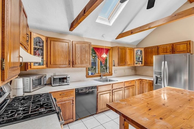 66 Guinan St, Waltham, MA 02451 - kitchen featuring stainless steel appliances, a skylight, beamed ceiling, glass insert cabinets, and brown cabinetry