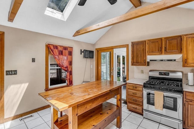 66 Guinan St, Waltham, MA 02451 - kitchen with gas stove, exhaust hood, a skylight, light tile patterned flooring, and brown cabinets