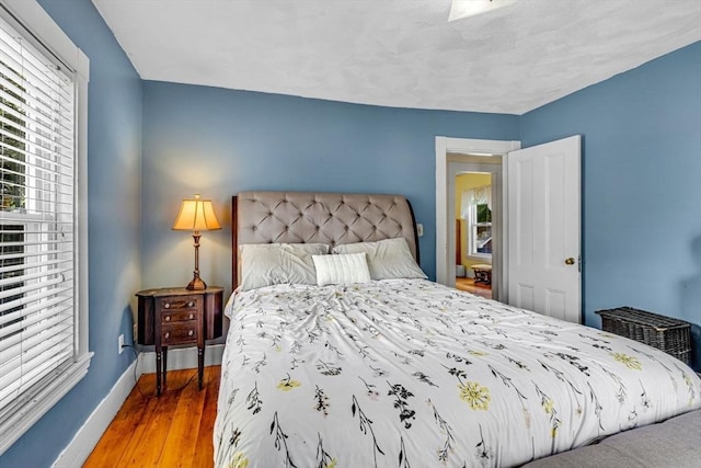 66 Guinan St, Waltham, MA 02451 - bedroom with baseboards and wood finished floors