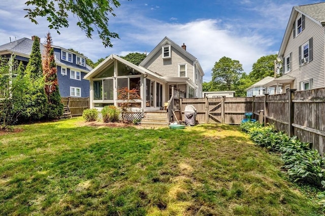 66 Guinan St, Waltham, MA 02451 - rear view of house with a sunroom, a chimney, a fenced backyard, and a gate