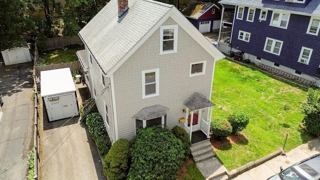 66 Guinan St, Waltham, MA 02451 - view of front of property with a chimney and a storage shed