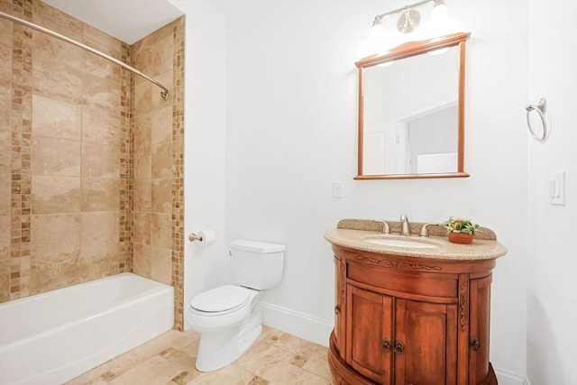 bathroom featuring shower / washtub combination, toilet, vanity, and baseboards