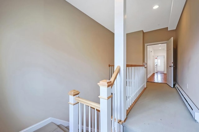 hall featuring an upstairs landing, recessed lighting, baseboards, and a baseboard radiator