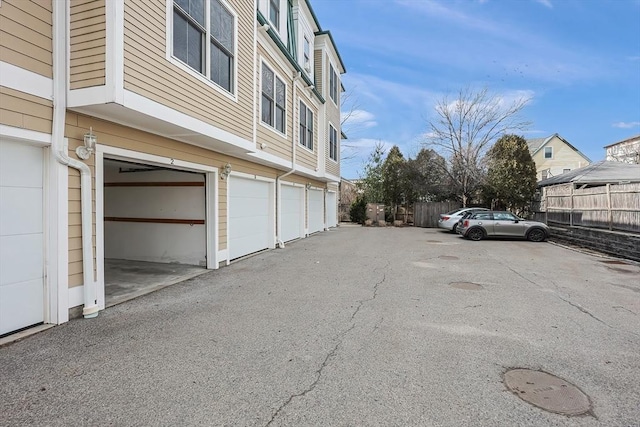 view of road featuring community garages