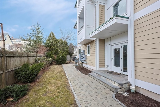 view of yard with french doors and fence