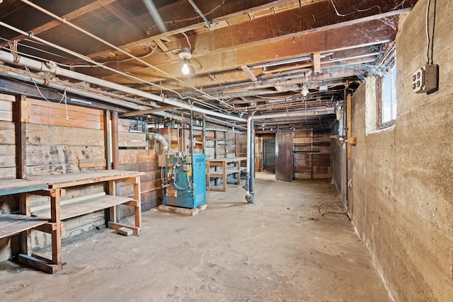 below grade area featuring a workshop area and a heating unit