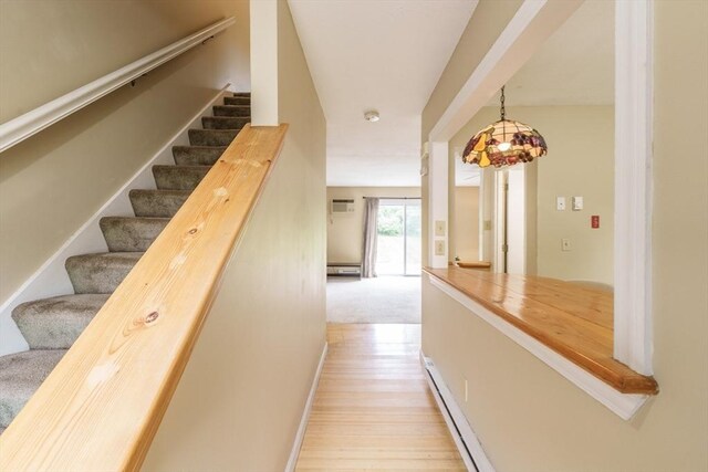 170 E Hadley Rd Unit 60, Amherst, MA 01002 - staircase with baseboard heating, wood finished floors, and an AC wall unit