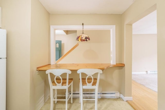 170 E Hadley Rd Unit 60, Amherst, MA 01002 - carpeted dining area with a baseboard heating unit and baseboards