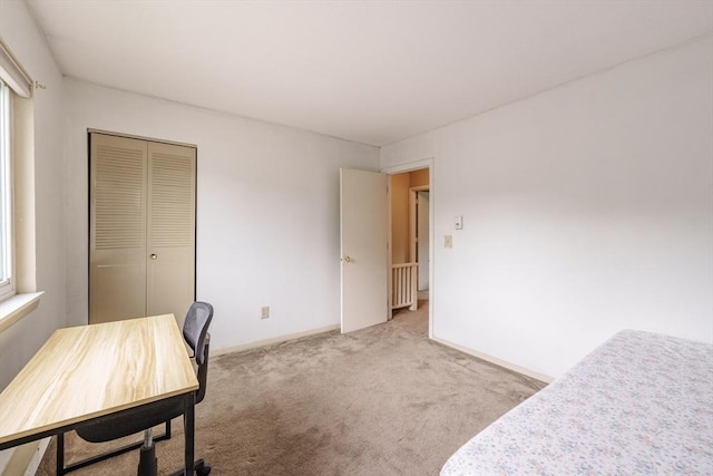 170 E Hadley Rd Unit 60, Amherst, MA 01002 - unfurnished bedroom featuring light colored carpet, a desk, and a closet