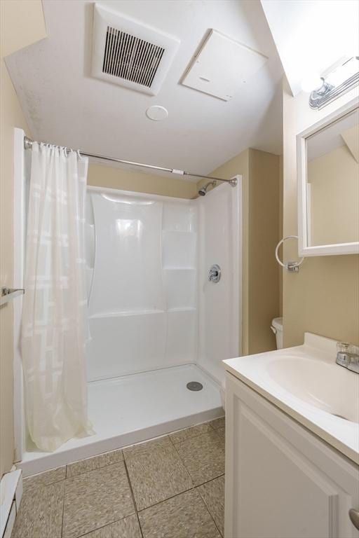 170 E Hadley Rd Unit 60, Amherst, MA 01002 - full bathroom featuring a shower with curtain, vanity, and a baseboard heating unit