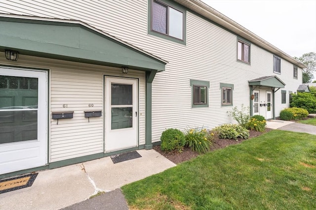 170 E Hadley Rd Unit 60, Amherst, MA 01002 - view of exterior entry with a lawn