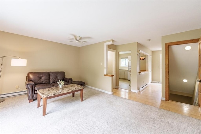 170 E Hadley Rd Unit 60, Amherst, MA 01002 - living area featuring light colored carpet, a baseboard radiator, ceiling fan, and light wood finished floors