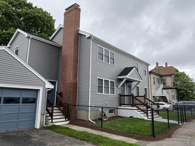 309 Farrington St, Quincy, MA 02170 - view of front of property with a chimney and a garage