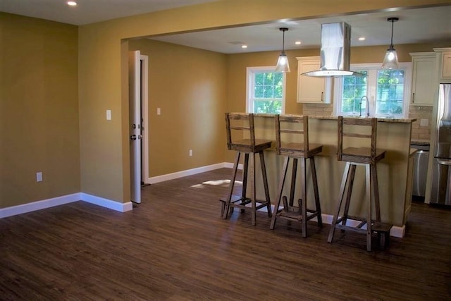 309 Farrington St, Quincy, MA 02170 - kitchen featuring dark wood-style floors, baseboards, white cabinetry, freestanding refrigerator, and a kitchen breakfast bar