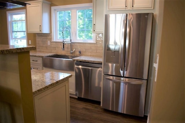 309 Farrington St, Quincy, MA 02170 - kitchen featuring appliances with stainless steel finishes, a sink, white cabinets, light stone countertops, and dark wood finished floors