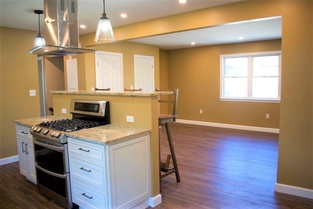 309 Farrington St, Quincy, MA 02170 - kitchen with double oven range, island range hood, a kitchen island, baseboards, and a breakfast bar area