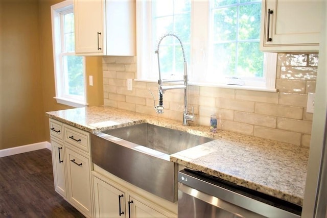 309 Farrington St, Quincy, MA 02170 - kitchen with dishwasher, a sink, tasteful backsplash, baseboards, and light stone counters