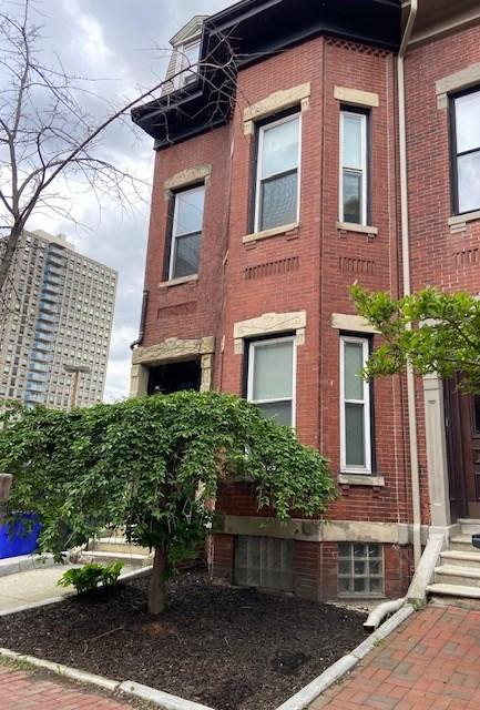 view of side of home with brick siding