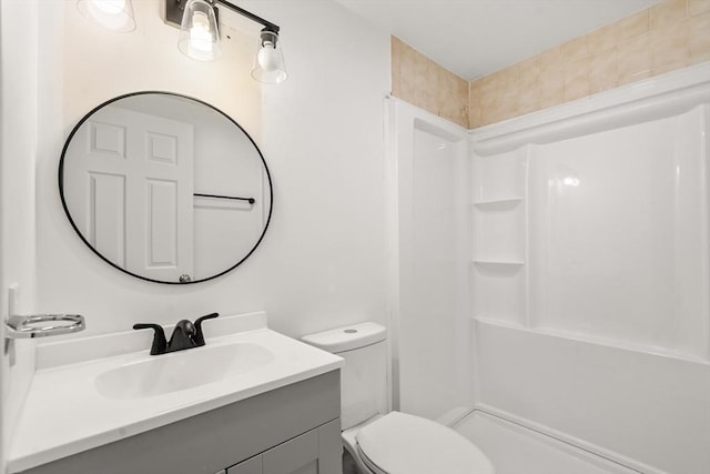 full bath featuring toilet, walk in shower, and vanity