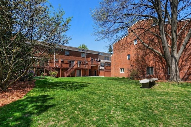 view of yard featuring stairs and a deck