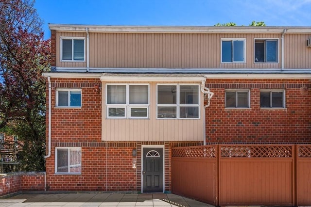 multi unit property with brick siding and fence