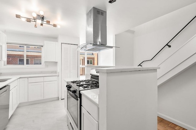 kitchen featuring stainless steel appliances, baseboards, island exhaust hood, light countertops, and white cabinets